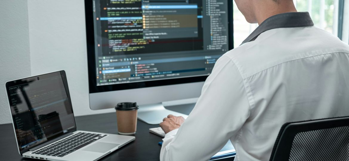 Male programmer working on website project in software development on the desktop computer